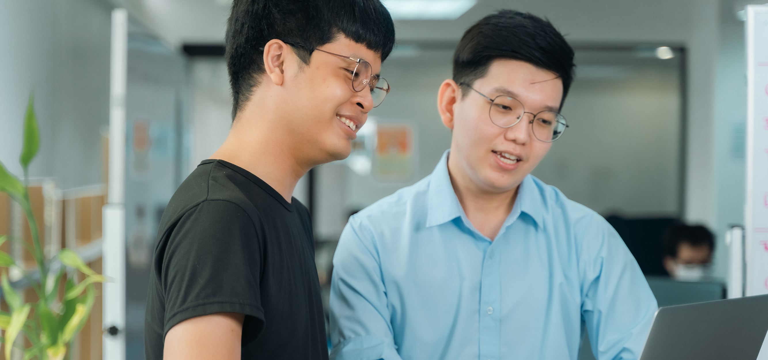 Two young men looking at a laptop screen