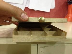 With the addition of the button, the user can easily tell it can be opened the same wooden box with a small button, affording a user to open it