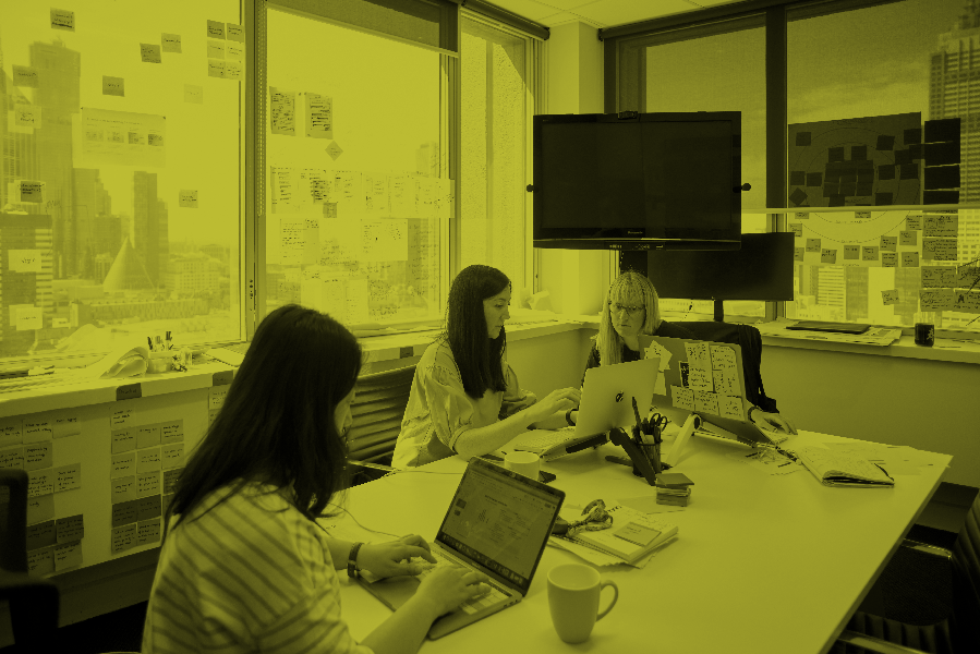 Three women working around a table