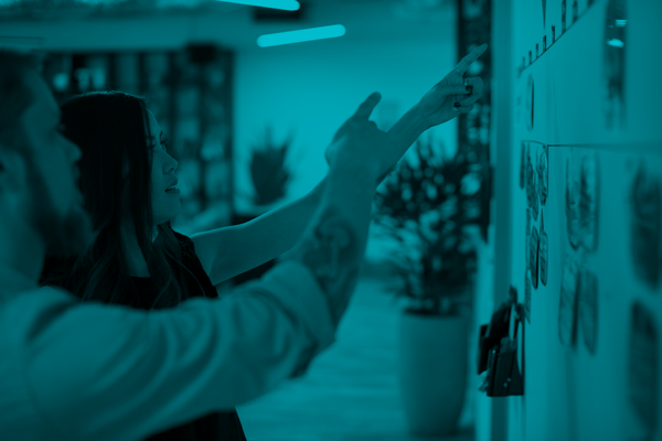 Two colleagues discuss story cards