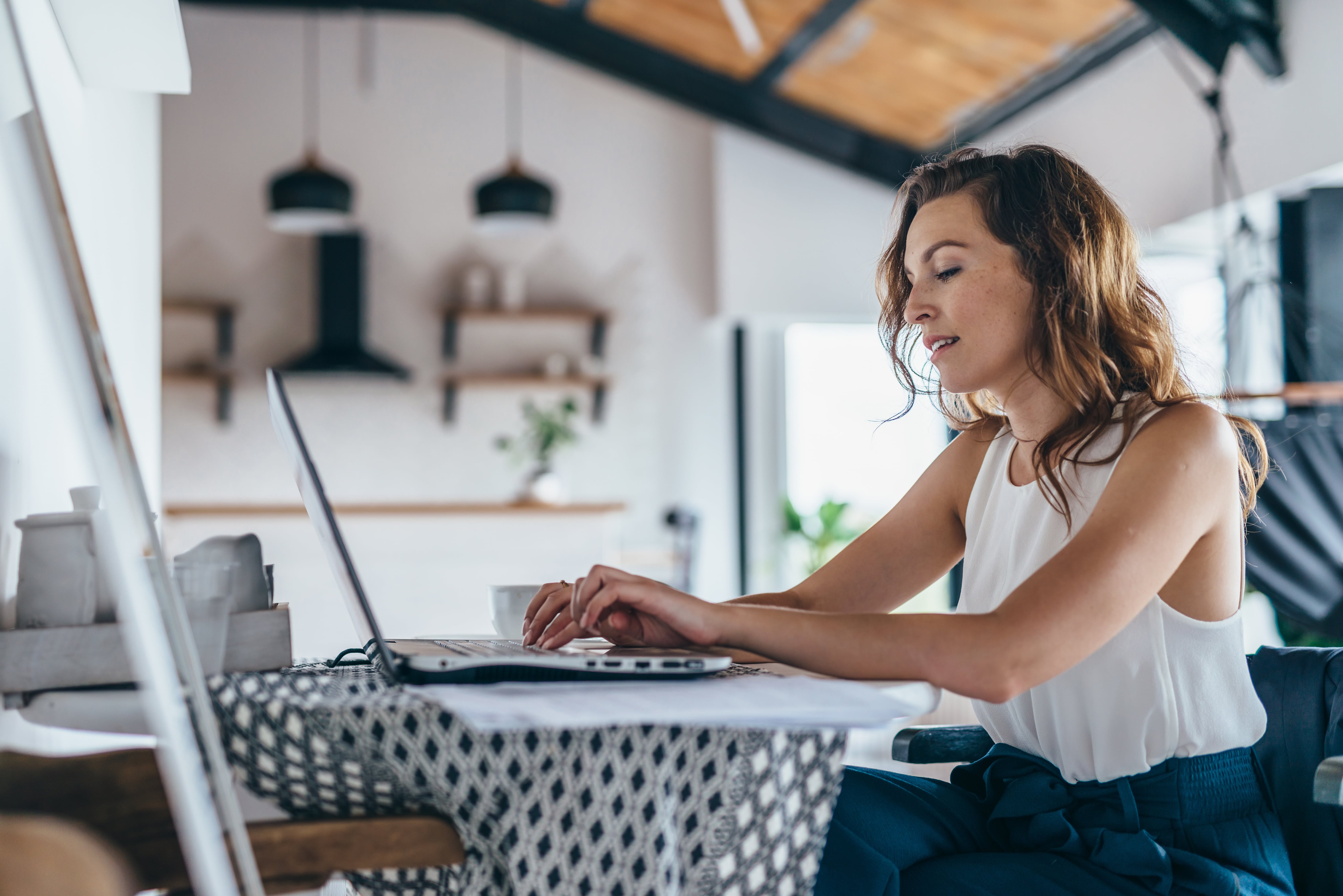 Woman working on her laptop at home