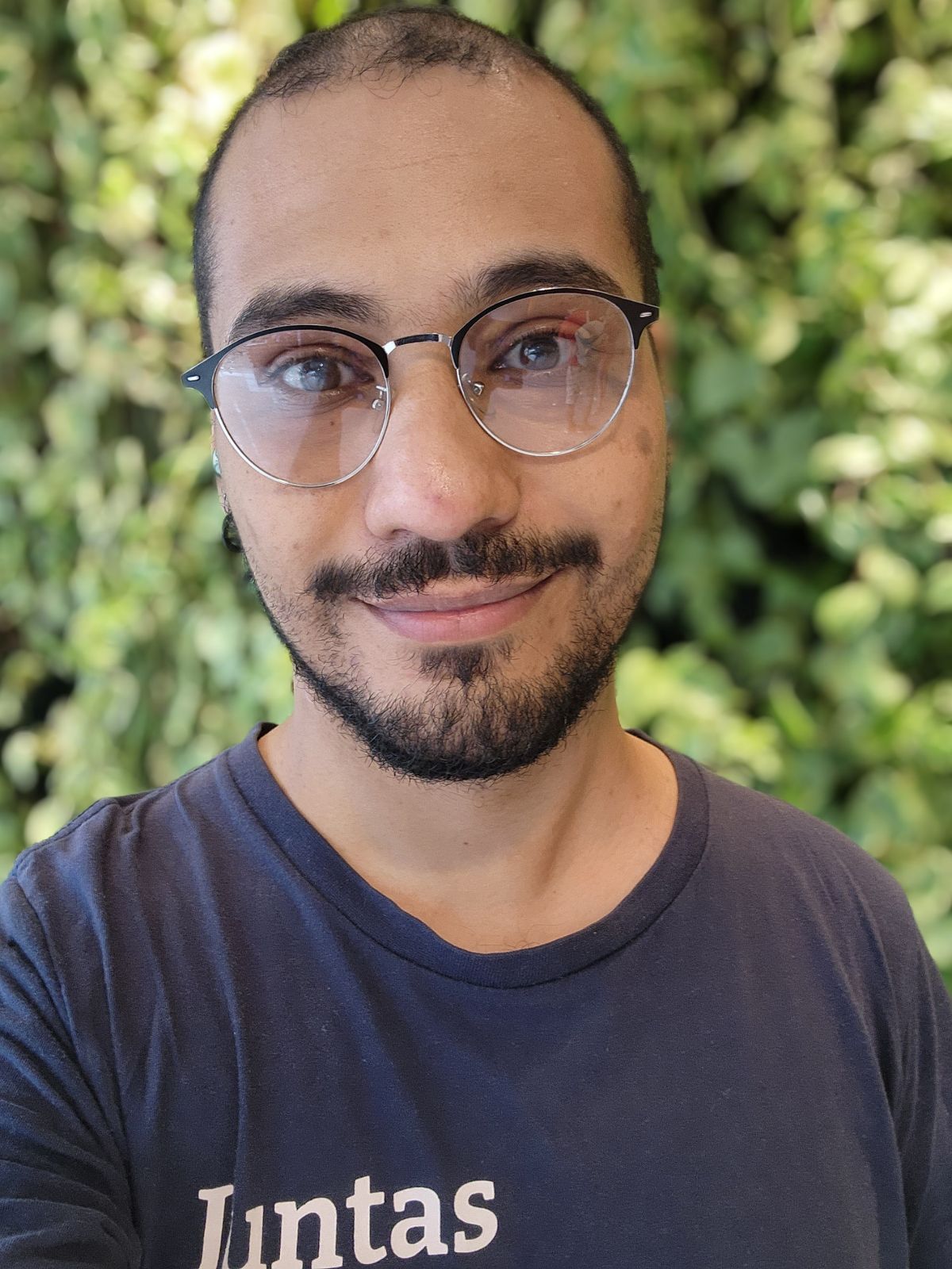 A man wearing glasses and a beard, along with a blue Thoughtworks T-shirt.